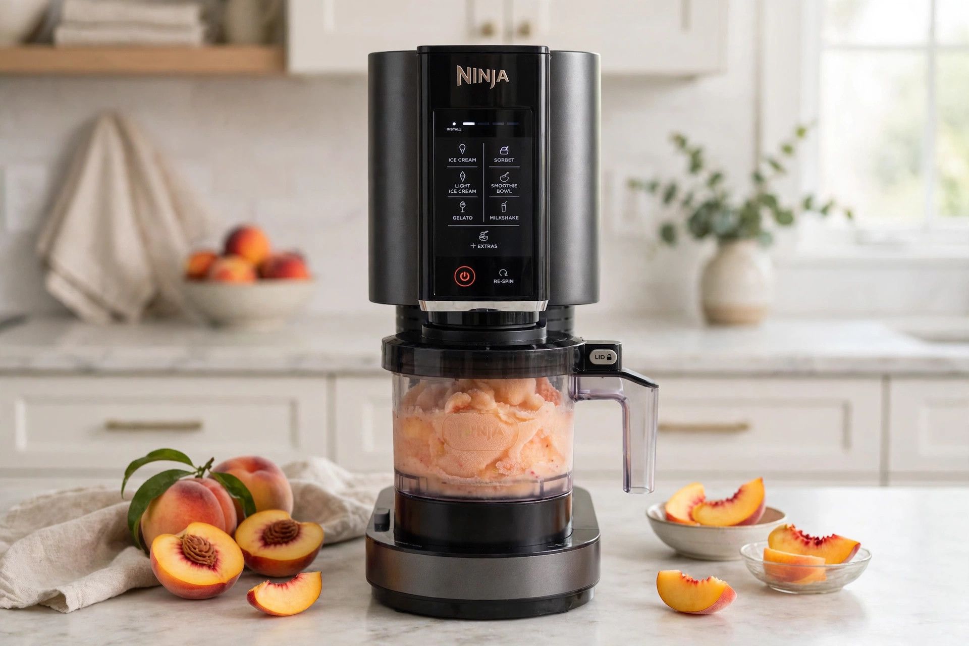 The frozen peach sorbet pint loaded into a countertop Ninja Creami machine, ready to spin