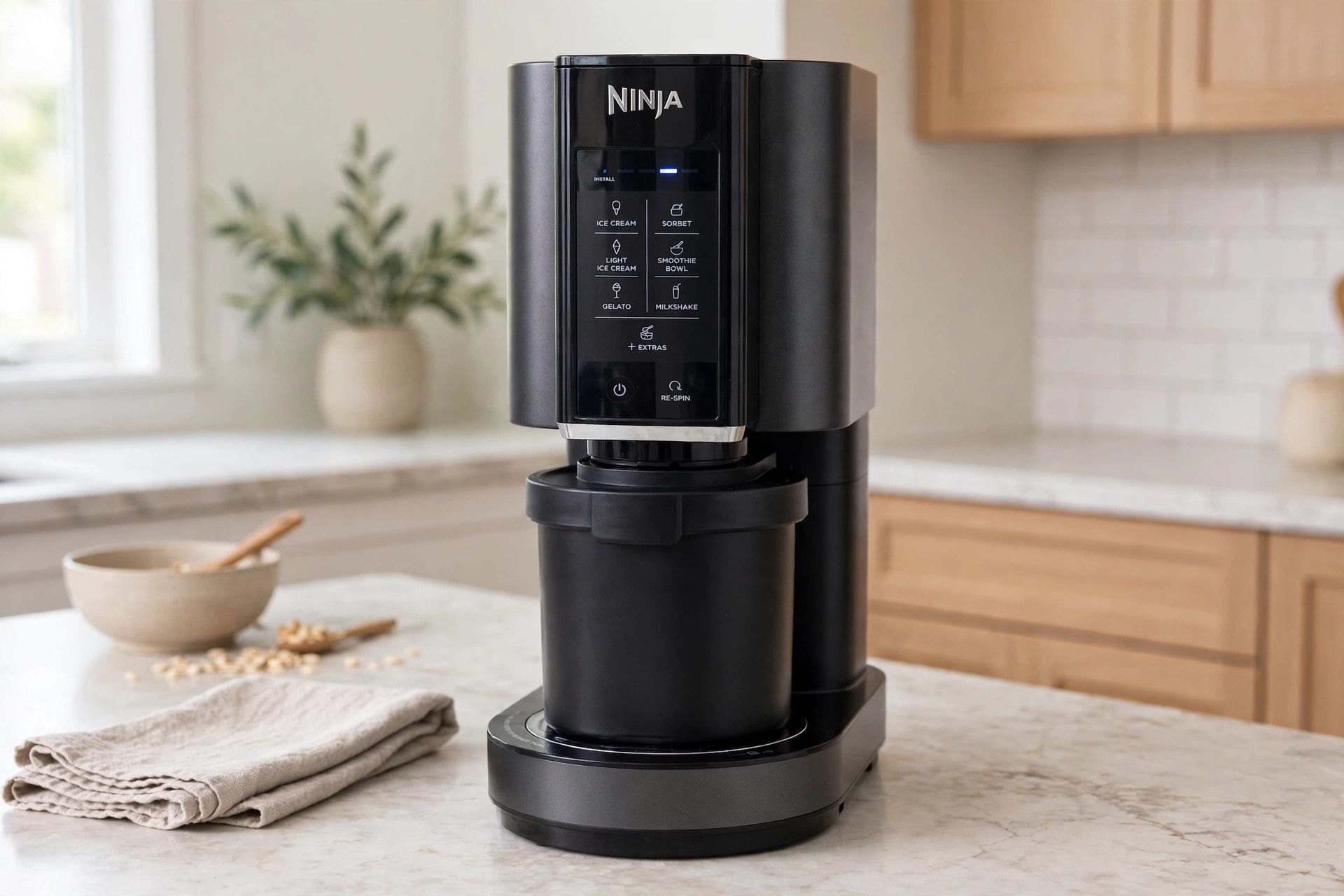 The frozen pumpkin pie pint loaded into a countertop Ninja Creami machine, ready to spin