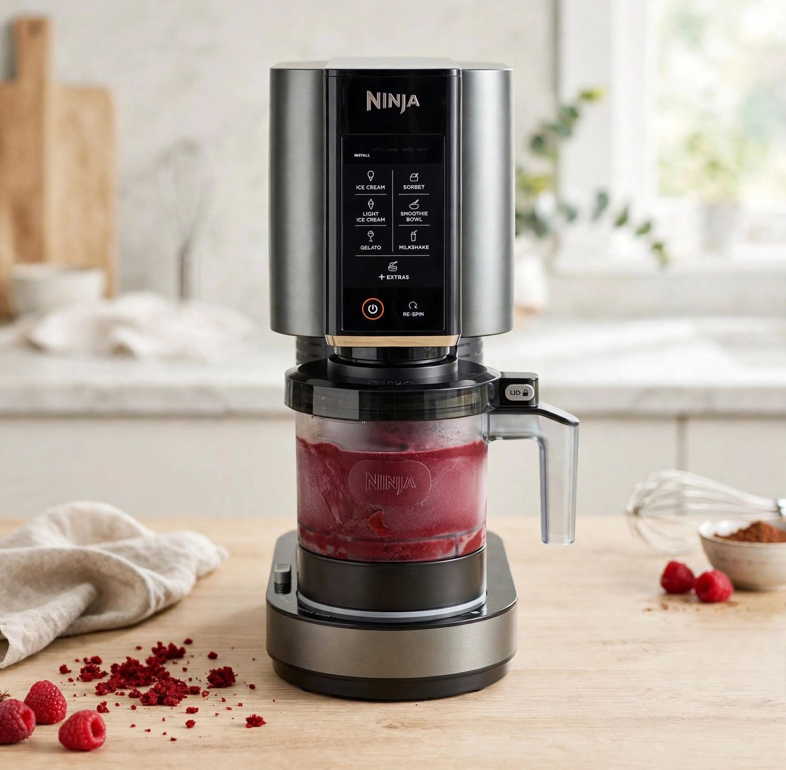 The frozen red velvet pint loaded into a countertop Ninja Creami machine, ready to spin